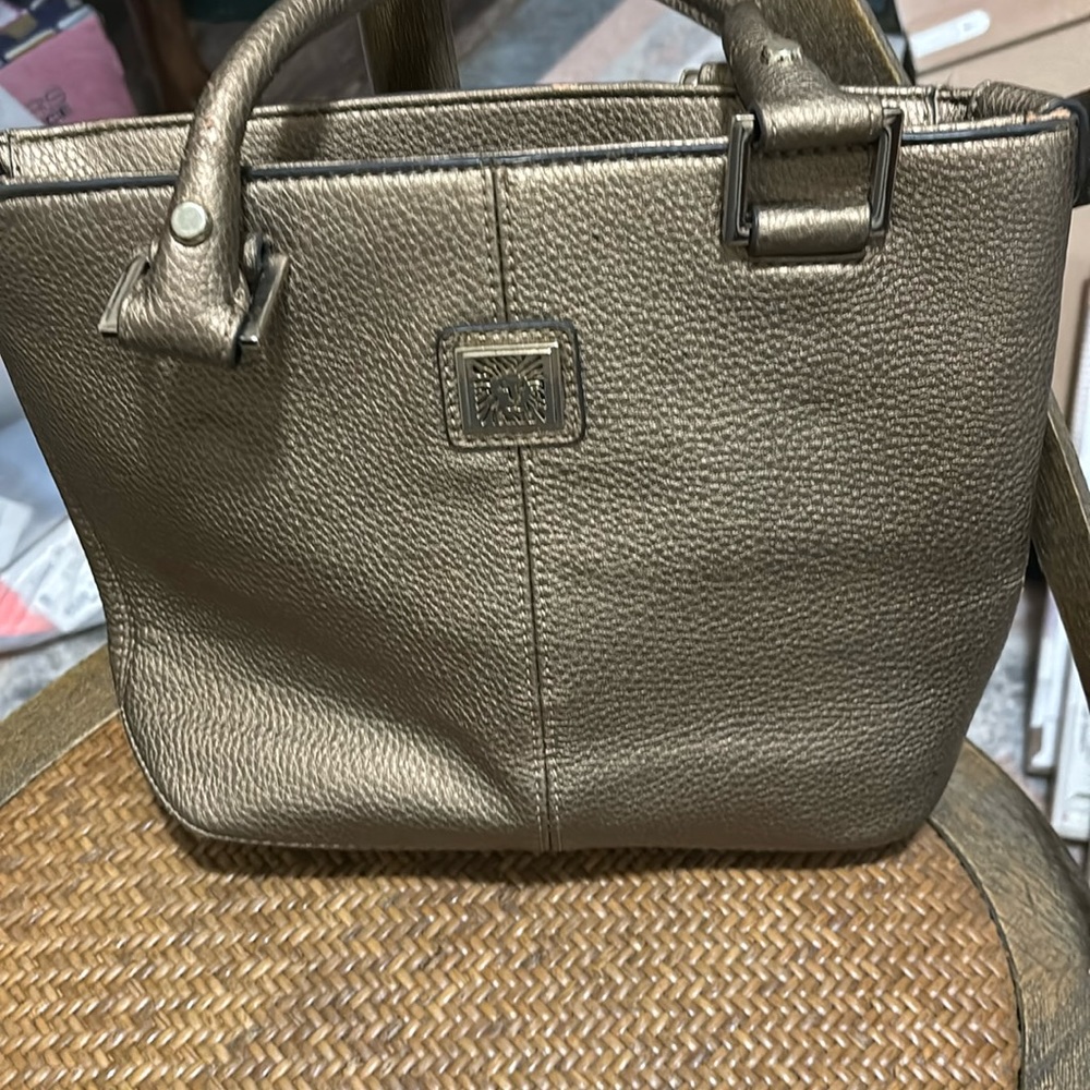 Anne Klein gold satchel. zip closure lining in great shape.  exterior wear.
